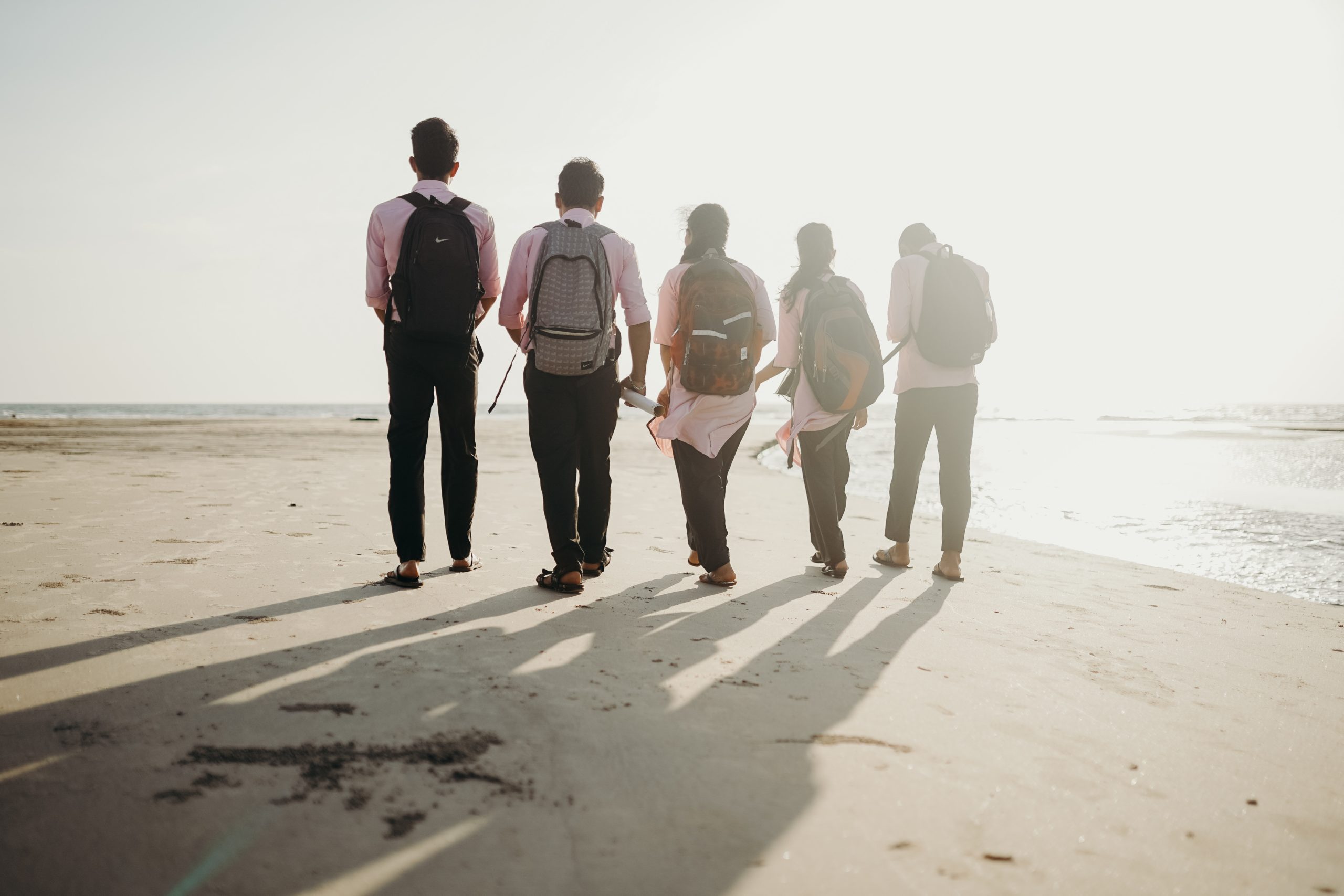 Group of friends walking on a beach