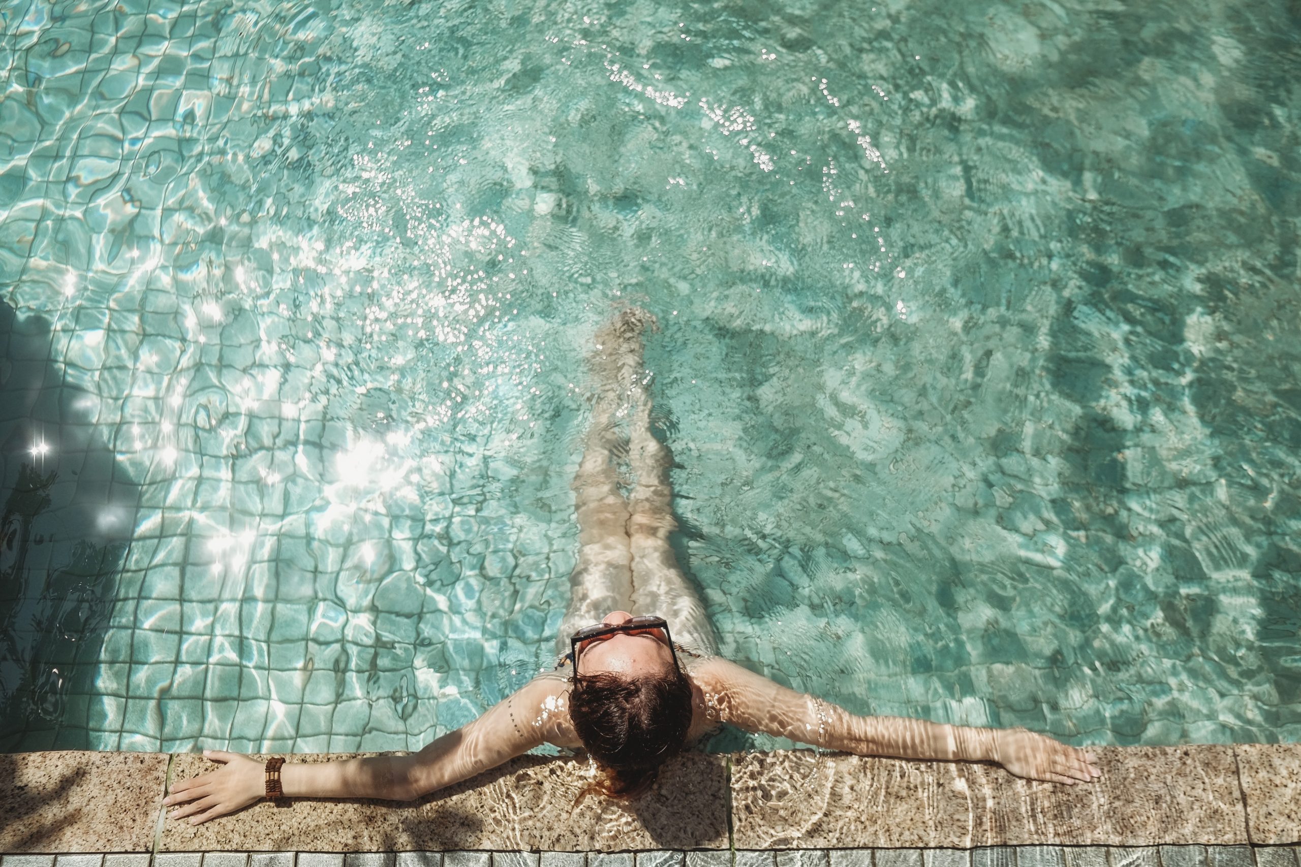 A person relaxing in a swimming pool