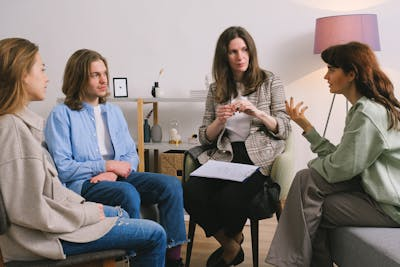 A woman talking to a support group