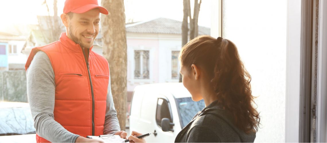 Delivery Man Giving Parcel To Woman